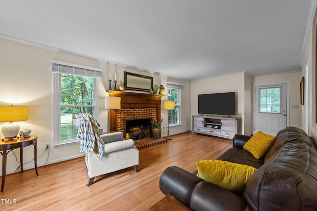 308 Trappers Sack Rd, Cary, NC 27513 - living room with ornamental molding, light wood finished floors, and a brick fireplace