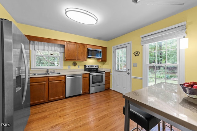 308 Trappers Sack Rd, Cary, NC 27513 - kitchen with stainless steel appliances, brown cabinets, light countertops, and light wood-style flooring