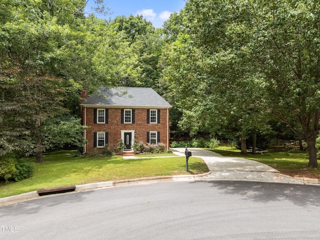 308 Trappers Sack Rd, Cary, NC 27513 - colonial house featuring brick siding, a front yard, and driveway