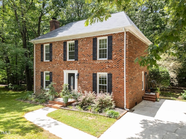 308 Trappers Sack Rd, Cary, NC 27513 - view of front of property with a chimney, brick siding, and a front yard