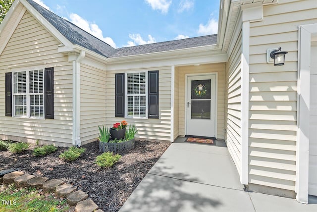 611 Quartz Dr, Durham, NC 27703 - view of exterior entry featuring roof with shingles