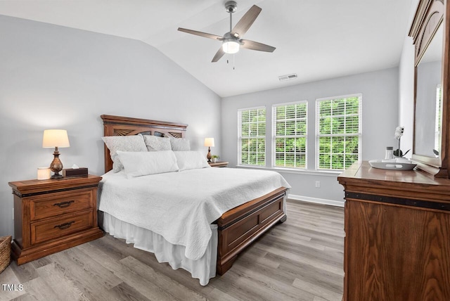 611 Quartz Dr, Durham, NC 27703 - bedroom featuring lofted ceiling, light wood-style flooring, and a ceiling fan