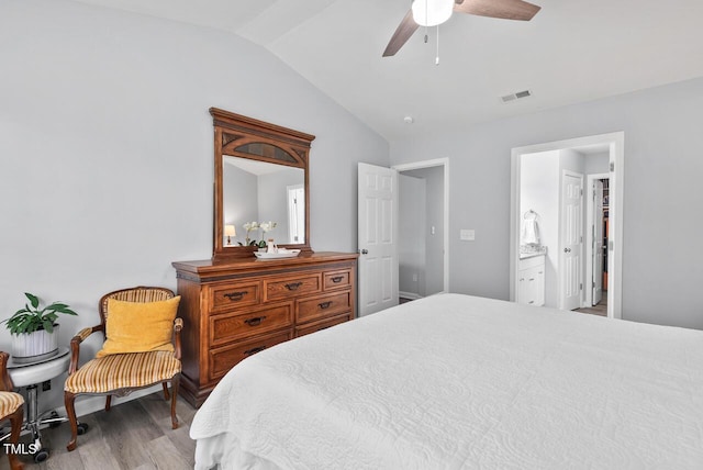 611 Quartz Dr, Durham, NC 27703 - bedroom featuring lofted ceiling, wood finished floors, connected bathroom, and a ceiling fan