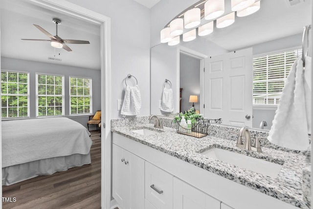 611 Quartz Dr, Durham, NC 27703 - bathroom with double vanity, wood finished floors, a ceiling fan, and ensuite bathroom
