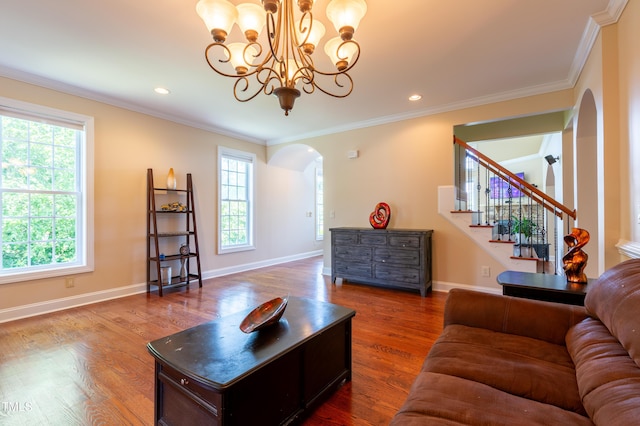 9701 Corktree Ct, Wake Forest, NC 27587 - living area with arched walkways, plenty of natural light, ornamental molding, a chandelier, and dark wood-style floors