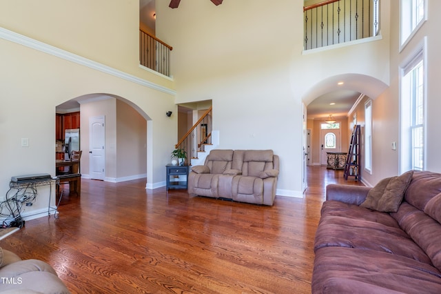 9701 Corktree Ct, Wake Forest, NC 27587 - living room featuring a high ceiling, wood finished floors, stairs, a ceiling fan, and crown molding