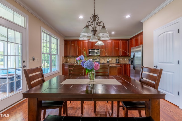 9701 Corktree Ct, Wake Forest, NC 27587 - dining space featuring a chandelier, ornamental molding, wood finished floors, and recessed lighting