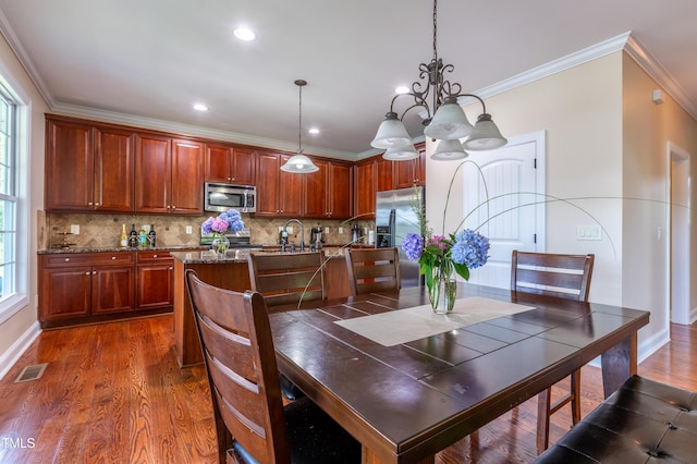 9701 Corktree Ct, Wake Forest, NC 27587 - dining room featuring dark wood-type flooring, ornamental molding, a chandelier, and recessed lighting