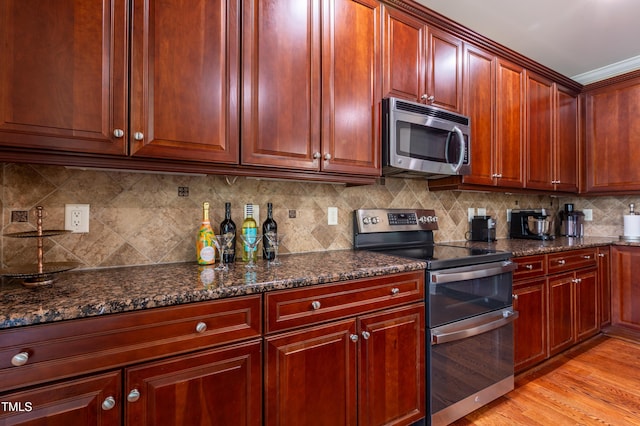 9701 Corktree Ct, Wake Forest, NC 27587 - kitchen featuring stainless steel appliances, dark brown cabinets, tasteful backsplash, and dark stone countertops