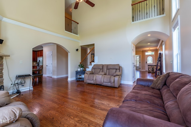 9701 Corktree Ct, Wake Forest, NC 27587 - living area with a high ceiling, arched walkways, a ceiling fan, dark wood-type flooring, and stairway