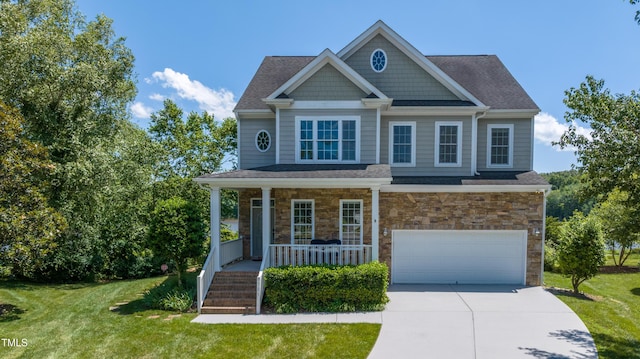 9701 Corktree Ct, Wake Forest, NC 27587 - craftsman house with covered porch, an attached garage, concrete driveway, and a front yard