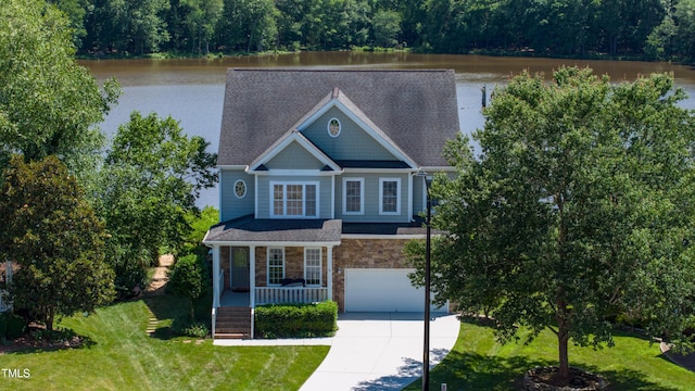 9701 Corktree Ct, Wake Forest, NC 27587 - view of front facade featuring a garage, concrete driveway, stone siding, a porch, and a water view