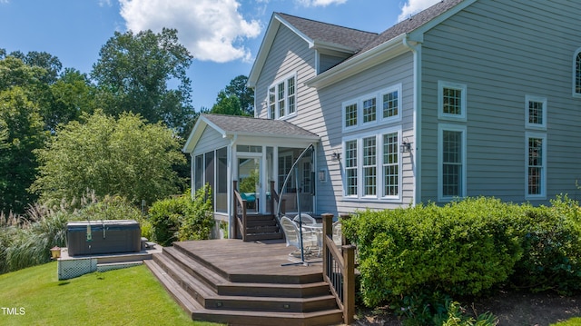 9701 Corktree Ct, Wake Forest, NC 27587 - back of property with a hot tub, a sunroom, a deck, a lawn, and roof with shingles