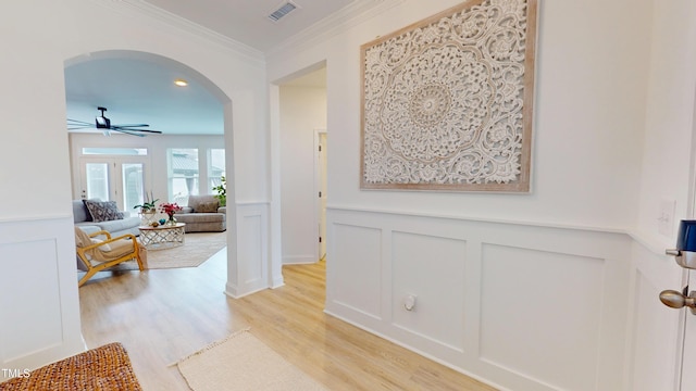 1720 Pinecliff Ct, Fuquay Varina, NC 27526 - corridor with arched walkways, a decorative wall, light wood finished floors, ornamental molding, and wainscoting