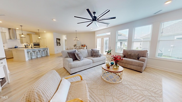 1720 Pinecliff Ct, Fuquay Varina, NC 27526 - living room featuring healthy amount of natural light, light wood-style floors, recessed lighting, and a ceiling fan