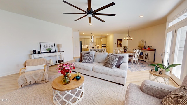 1720 Pinecliff Ct, Fuquay Varina, NC 27526 - living room with light wood finished floors, a ceiling fan, recessed lighting, and a chandelier