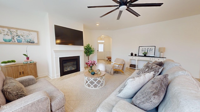 1720 Pinecliff Ct, Fuquay Varina, NC 27526 - living area with arched walkways, ceiling fan, wood finished floors, and a glass covered fireplace