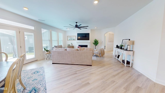 1720 Pinecliff Ct, Fuquay Varina, NC 27526 - living room with a ceiling fan, a fireplace, light wood-style flooring, arched walkways, and recessed lighting