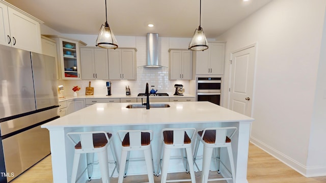 1720 Pinecliff Ct, Fuquay Varina, NC 27526 - kitchen with wall chimney range hood, appliances with stainless steel finishes, decorative backsplash, a kitchen bar, and recessed lighting