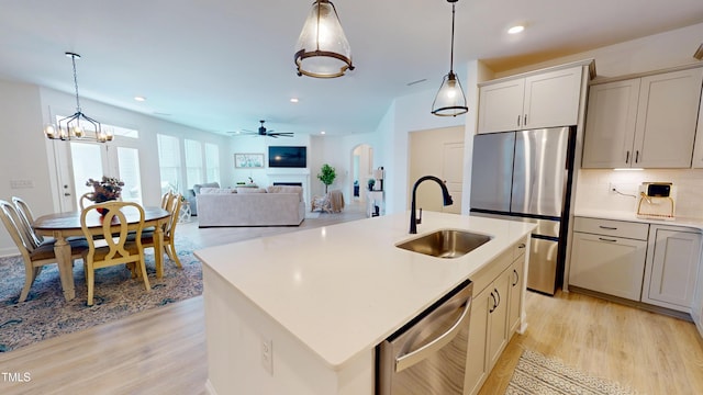 1720 Pinecliff Ct, Fuquay Varina, NC 27526 - kitchen featuring appliances with stainless steel finishes, light wood-style flooring, light countertops, tasteful backsplash, and recessed lighting