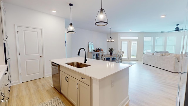 1720 Pinecliff Ct, Fuquay Varina, NC 27526 - kitchen with stainless steel dishwasher, light wood-style flooring, a kitchen island with sink, light countertops, and decorative light fixtures