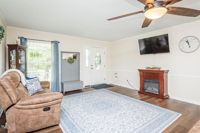 2120 Northcrest Dr, Elon, NC 27244 - living area with plenty of natural light, wood finished floors, ornamental molding, ceiling fan, and a glass covered fireplace