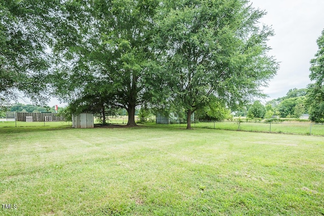 2120 Northcrest Dr, Elon, NC 27244 - fenced backyard featuring a storage unit