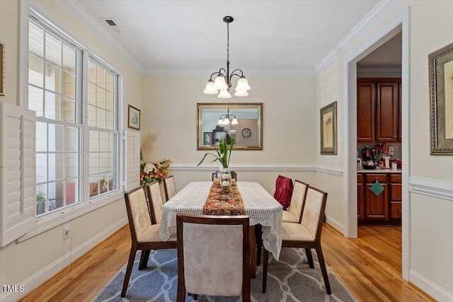 23 Northern Way Ct, Durham, NC 27712 - dining space with a chandelier, light wood-style flooring, healthy amount of natural light, and crown molding
