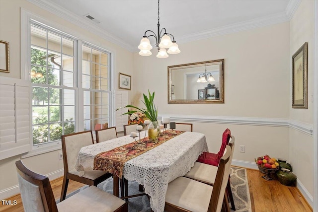 23 Northern Way Ct, Durham, NC 27712 - dining space with a chandelier, wood finished floors, and crown molding