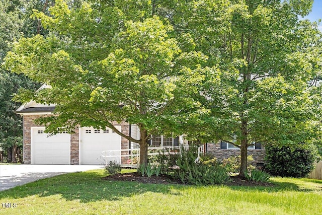 23 Northern Way Ct, Durham, NC 27712 - view of property hidden behind natural elements with stone siding, a front yard, and driveway