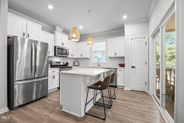 2321 Blue Crab Ct, Wake Forest, NC 27587 - kitchen with stainless steel appliances, crown molding, backsplash, white cabinets, and light countertops