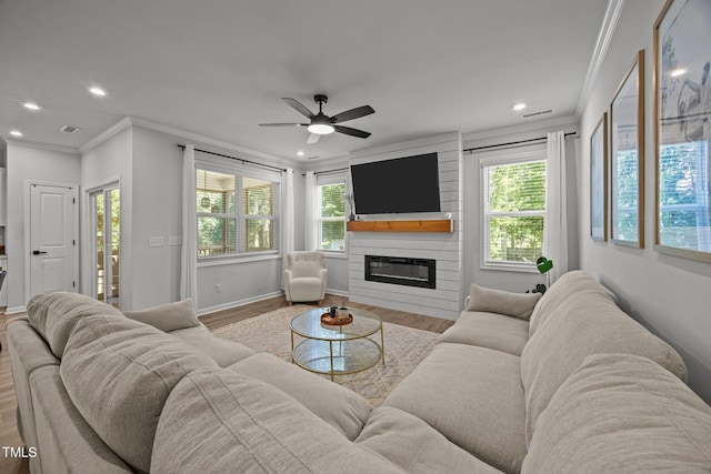 2321 Blue Crab Ct, Wake Forest, NC 27587 - living room with ornamental molding, a fireplace, wood finished floors, plenty of natural light, and a ceiling fan
