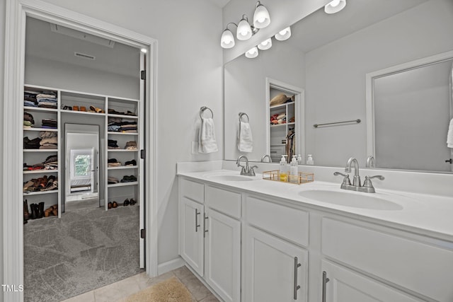 2321 Blue Crab Ct, Wake Forest, NC 27587 - bathroom featuring a spacious closet, double vanity, and tile patterned floors
