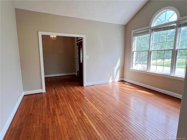 333 Westwater Way, Fayetteville, NC 28301 - empty room with wood-type flooring, a chandelier, and lofted ceiling
