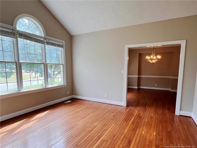 333 Westwater Way, Fayetteville, NC 28301 - unfurnished room featuring a chandelier, light wood-style flooring, and lofted ceiling