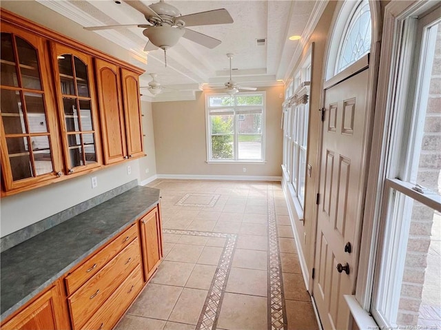 333 Westwater Way, Fayetteville, NC 28301 - kitchen featuring a tray ceiling, glass insert cabinets, ceiling fan, dark countertops, and crown molding
