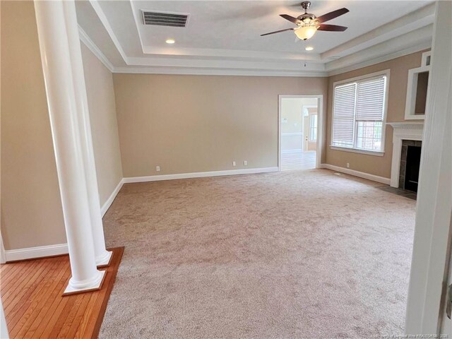 333 Westwater Way, Fayetteville, NC 28301 - unfurnished living room with a tray ceiling, ceiling fan, ornate columns, a tiled fireplace, and recessed lighting
