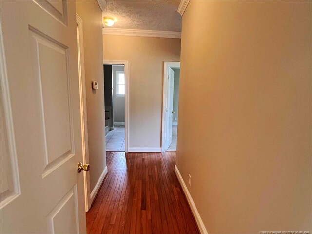 333 Westwater Way, Fayetteville, NC 28301 - hall featuring crown molding, dark wood finished floors, and a textured ceiling