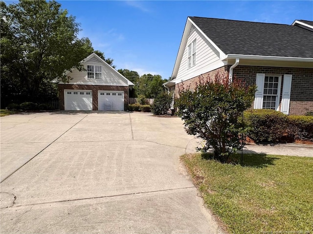 333 Westwater Way, Fayetteville, NC 28301 - view of side of home with brick siding, a detached garage, and a shingled roof