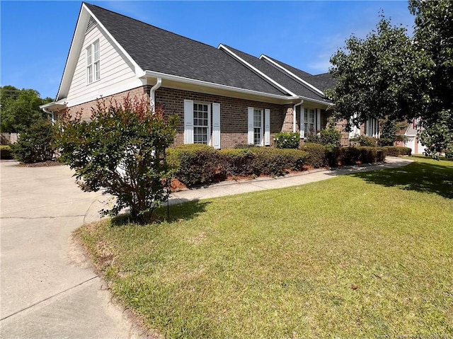 333 Westwater Way, Fayetteville, NC 28301 - view of side of home with brick siding, a yard, and a shingled roof