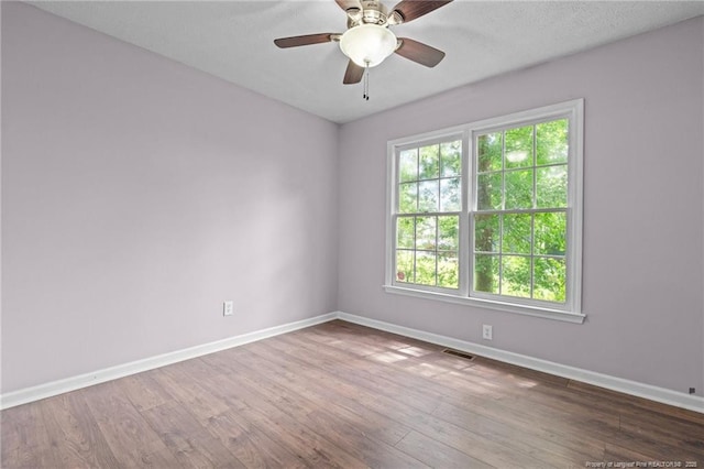 40 Blue Heron Ct, Sanford, NC 27332 - empty room with wood finished floors and a ceiling fan
