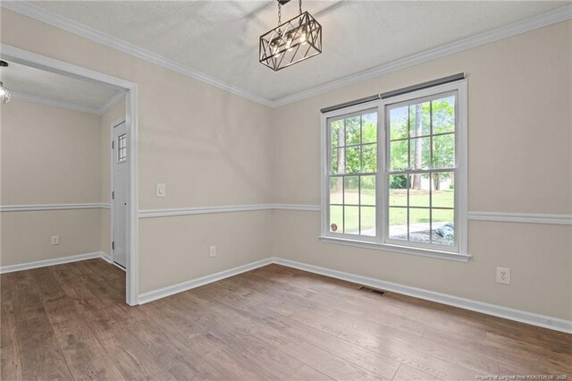 40 Blue Heron Ct, Sanford, NC 27332 - spare room with a chandelier, wood finished floors, healthy amount of natural light, and ornamental molding