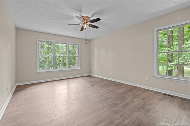 40 Blue Heron Ct, Sanford, NC 27332 - empty room featuring a ceiling fan, wood finished floors, and a textured ceiling