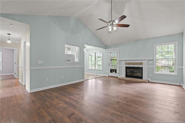 40 Blue Heron Ct, Sanford, NC 27332 - unfurnished living room featuring ceiling fan, wood finished floors, plenty of natural light, a glass covered fireplace, and high vaulted ceiling