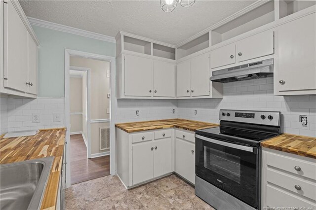 40 Blue Heron Ct, Sanford, NC 27332 - kitchen with stainless steel electric range oven, butcher block countertops, under cabinet range hood, crown molding, and white cabinets
