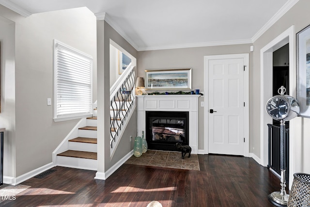 627 New Rd, Raleigh, NC 27608 - living area with dark wood finished floors, stairway, crown molding, and a fireplace with flush hearth