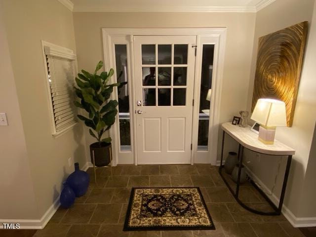 627 New Rd, Raleigh, NC 27608 - doorway with ornamental molding and baseboards