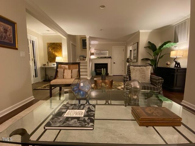 627 New Rd, Raleigh, NC 27608 - living room with a fireplace and ornamental molding