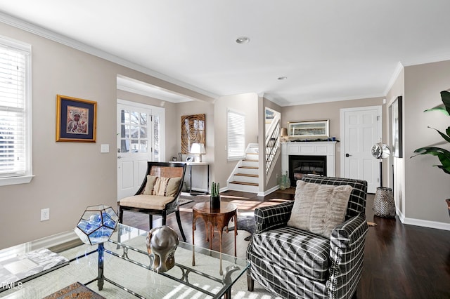 627 New Rd, Raleigh, NC 27608 - living room with dark wood-style flooring, healthy amount of natural light, a glass covered fireplace, ornamental molding, and recessed lighting