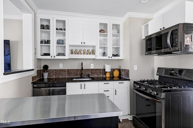 627 New Rd, Raleigh, NC 27608 - kitchen with black range with gas cooktop, stainless steel microwave, dishwashing machine, white cabinets, and crown molding